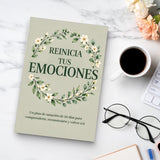 Desk reading setup with Reinicia Tus Emociones wellness workbook