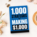 1,000 Strategies for Making $1,000 - paperback beside writing materials