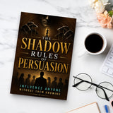 The Shadow Rules of Persuasion - paperback beside a cup