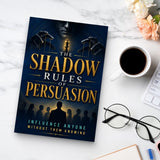 The Shadow Rules of Persuasion - paperback beside a cup