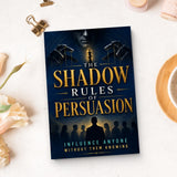 The Shadow Rules of Persuasion - paperback beside writing materials